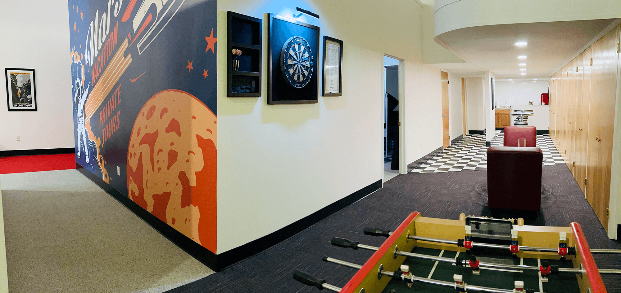 Photo of DatAchieve breakroom with darts and foosball table.